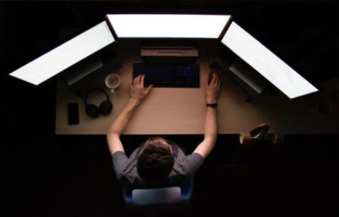Person at multiple computer monitors
