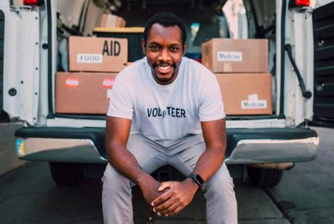 Man sitting on back of truck
