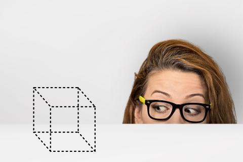 woman looking at a cube