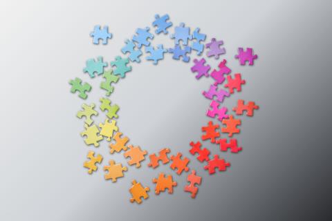 rainbow colored puzzle pieces form a circle