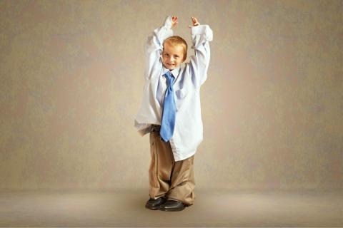 Young boy wearing clothes that are too big