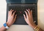 Hands on a laptop keyboard