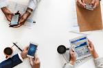 People in a meeting with devices