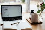 Laptop and book on desk
