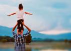 Kid on adult's shoulders