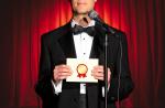 Man holding an awards envelope