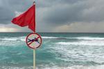 Red flag on stormy beach