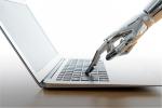 Robot typing on laptop keyboard